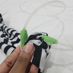 I had cut 2 holes in the prototype I created, and used both glue and tape to stick the tubes onto the prototype. One hole was for air to go in, and the other was for air to go out. It was difficult to use because the glue and tape were flimsy, and made the prototype fall apart at times.