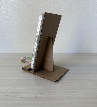 Then we built it with the same materials, but using less cardboard and glue to create a more efficient phone holder.
